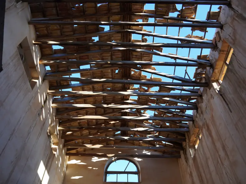 Damaged roof trusses exposed to open sky