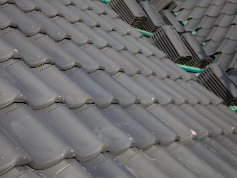 Close-up of glossy gray clay roof tiles.