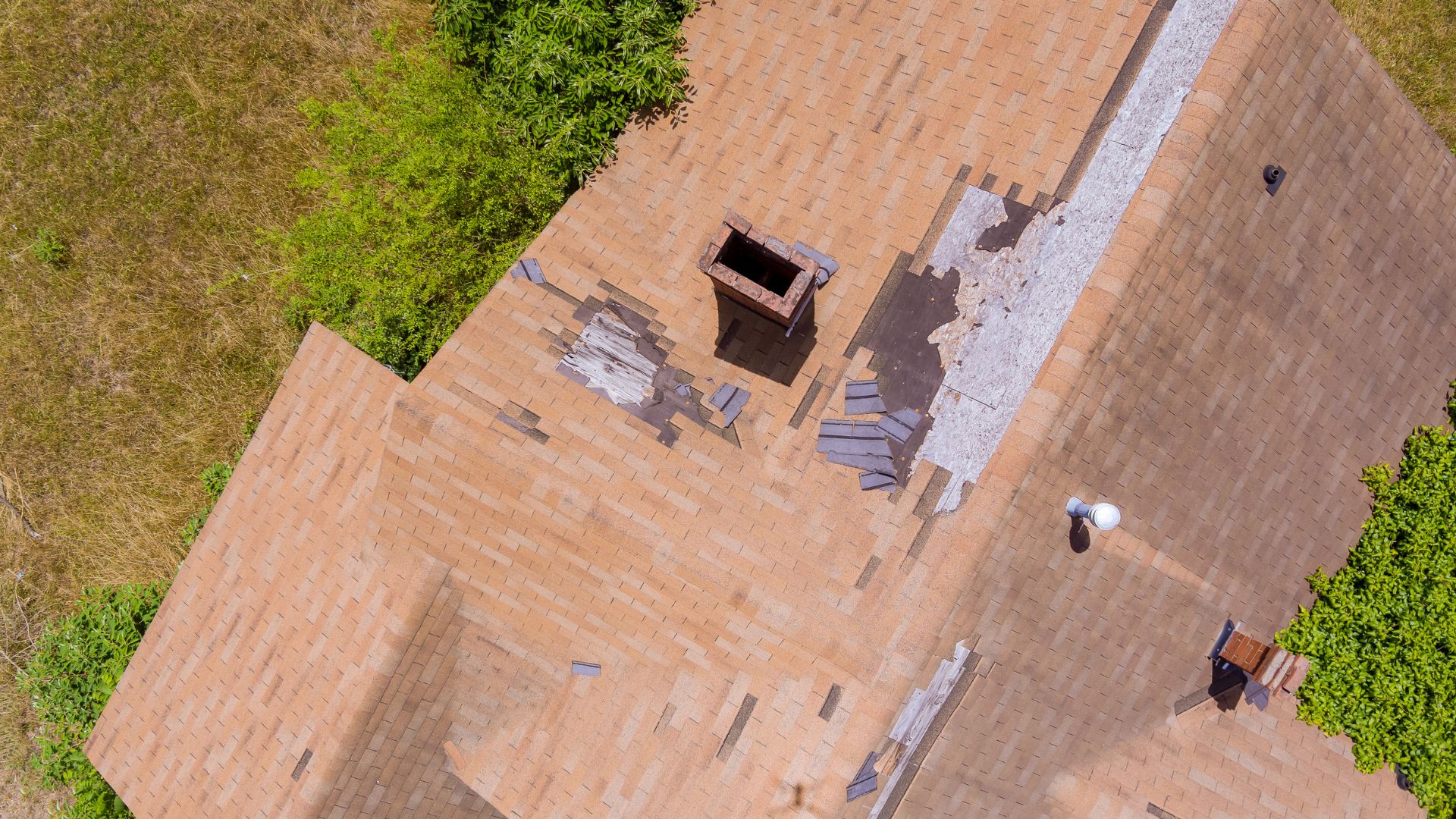 Alt & Alt crew installing architectural asphalt shingles during a roof replacement on a two-story home in Tallmadge, Ohio