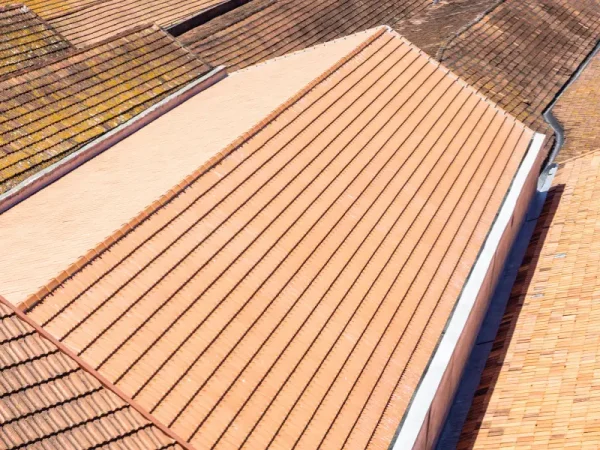 Aerial view of mismatched tile roof sections on adjoining buildings.