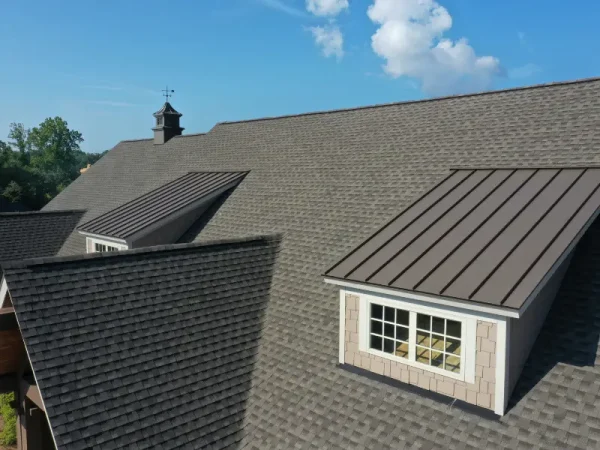 Shingle roof with metal-clad dormer windows.