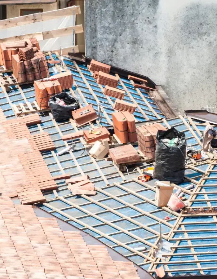 Aerial view of roof battens with stacked clay tiles ready for install.